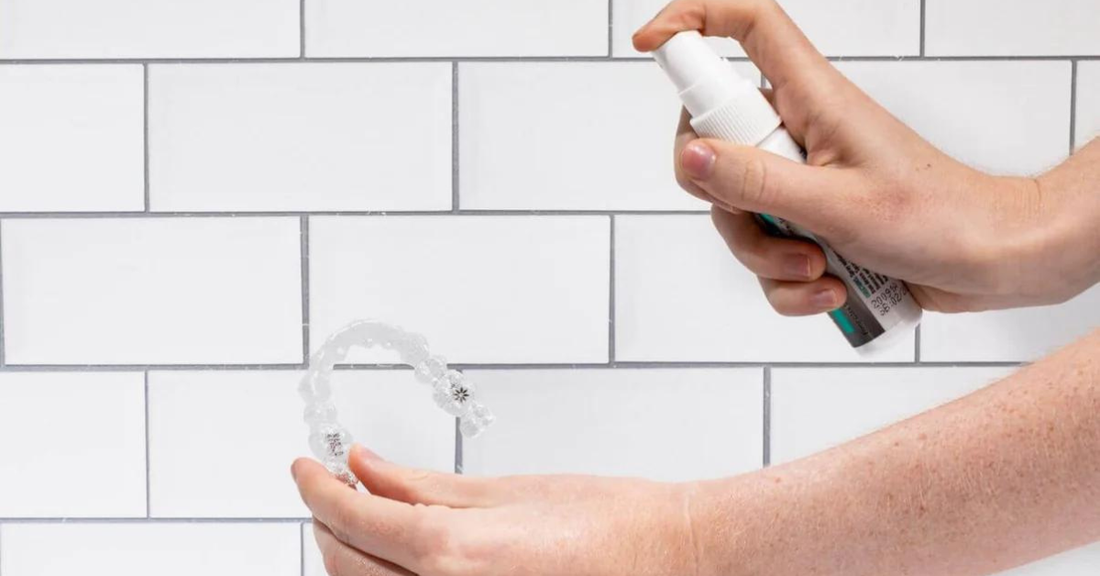 Image showing a bottle of invisalign cleaning foam with an Invisalign aligner.
