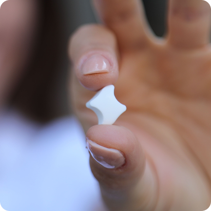 Close-up of woman's hand holding a Movemint Aligner Mint