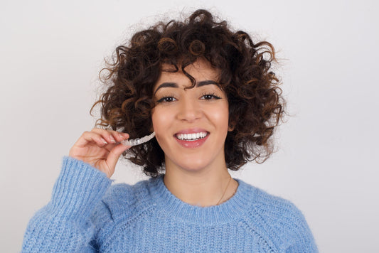 young man having aligner placed by orthodontist