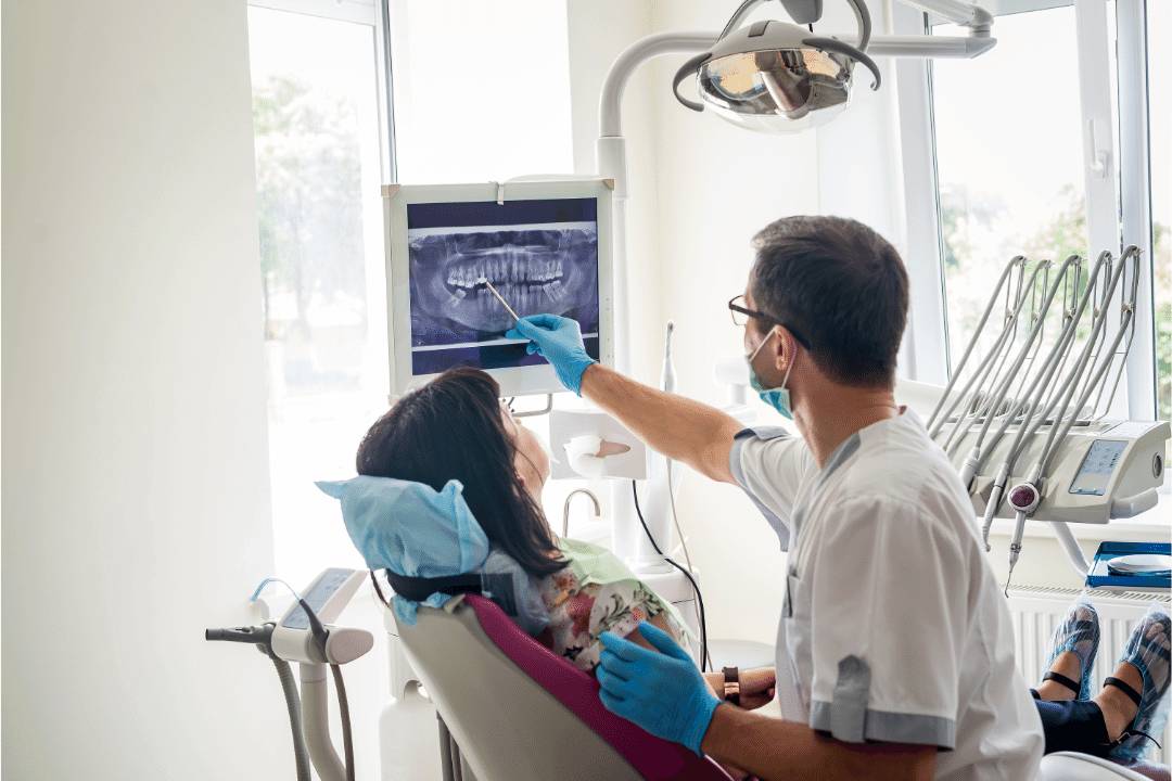 orthodontist pointing out teeth on x ray